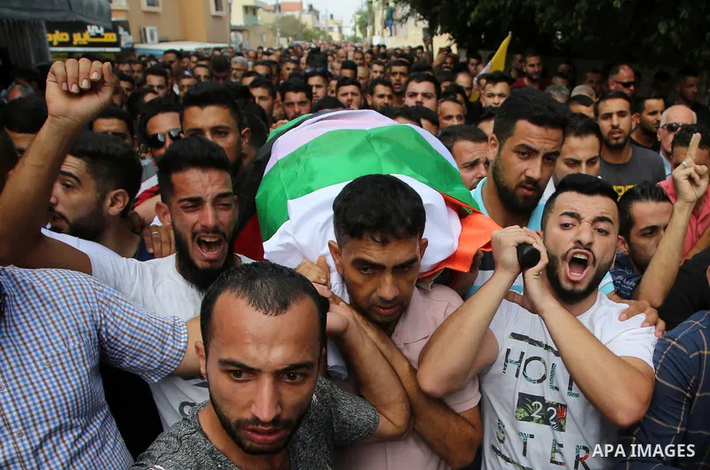 Palestinian mourners carry the body of Aisha al-Rabi, 48, during her funeral in the West Bank village of Becya, near The West Bank City of Salfit, 13 October 2018. According to media reports, al-Rabi was killed while her...