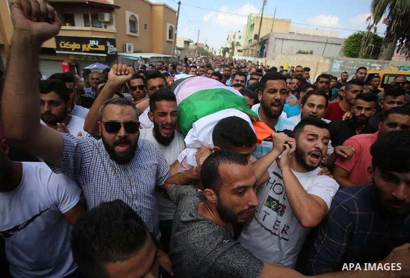 Palestinian mourners carry the body of Aisha al-Rabi, 48, during her funeral in the West Bank village of Becya, near The West Bank City of Salfit, 13 October 2018. According to media reports, al-Rabi was killed while her...
