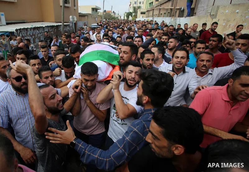 Palestinian mourners carry the body of Aisha al-Rabi, 48, during her funeral in the West Bank village of Becya, near The West Bank City of Salfit, 13 October 2018. According to media reports, al-Rabi was killed while her...