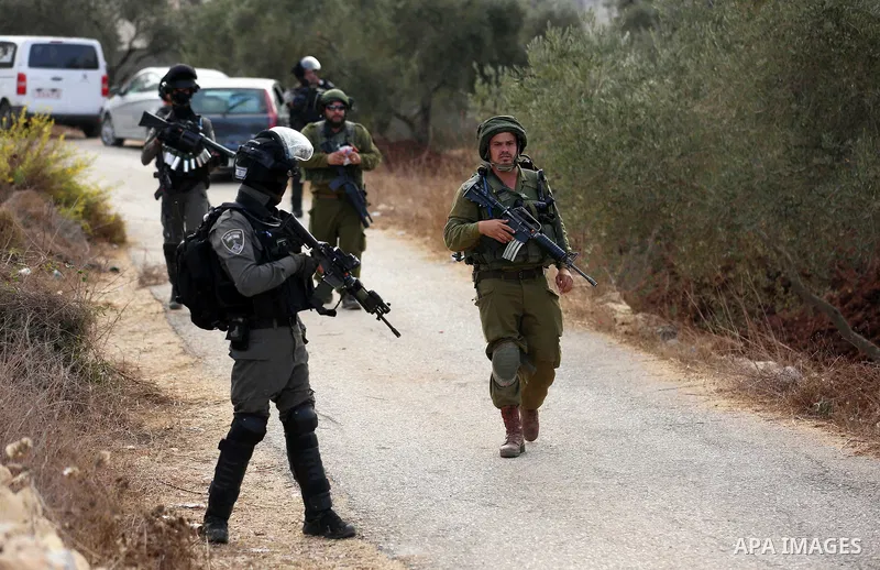 Israeli soldiers take position during clashes with Palestinian order to shut down a Palestinian school in the West Bank city of Nablus, on October 15, 2018. Photo by Shadi Jarar'ah