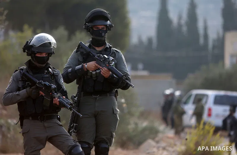 Israeli soldiers take position during clashes with Palestinian order to shut down a Palestinian school in the West Bank city of Nablus, on October 15, 2018. Photo by Shadi Hatem