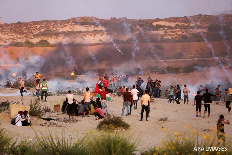 Palestinian protesters gather during clashes with Israeli forces in a demonstration against the Israeli blockade on Gaza Strip, along the Gaza sea barrier on the maritime border with Israel near Kibbutz Zikim, north of B...