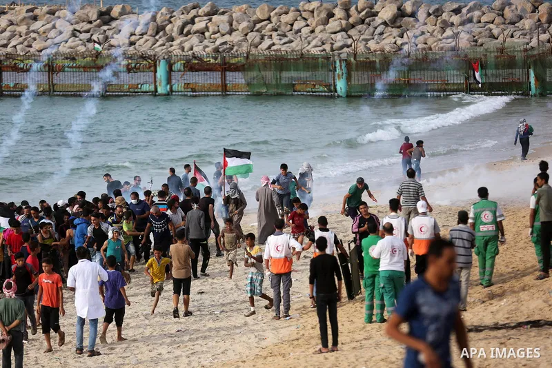 Palestinian protesters gather during clashes with Israeli forces in a demonstration against the Israeli blockade on Gaza Strip, along the Gaza sea barrier on the maritime border with Israel near Kibbutz Zikim, north of B...
