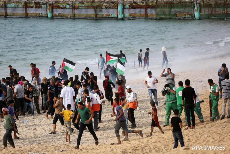 Palestinian protesters gather during clashes with Israeli forces in a demonstration against the Israeli blockade on Gaza Strip, along the Gaza sea barrier on the maritime border with Israel near Kibbutz Zikim, north of B...