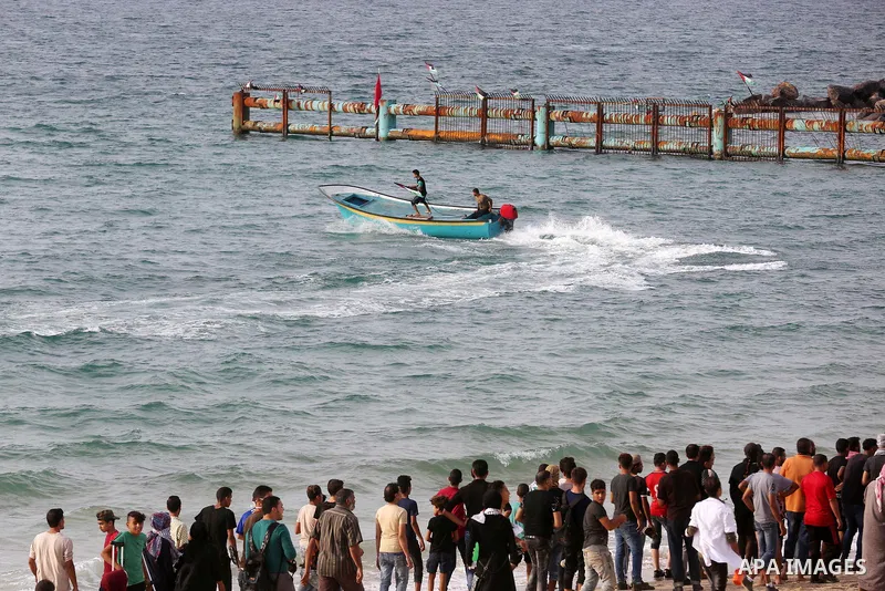 Palestinian protesters gather during clashes with Israeli forces in a demonstration against the Israeli blockade on Gaza Strip, along the Gaza sea barrier on the maritime border with Israel near Kibbutz Zikim, north of B...