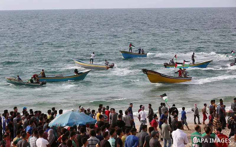 Palestinian protesters gather during clashes with Israeli forces in a demonstration against the Israeli blockade on Gaza Strip, along the Gaza sea barrier on the maritime border with Israel near Kibbutz Zikim, north of B...