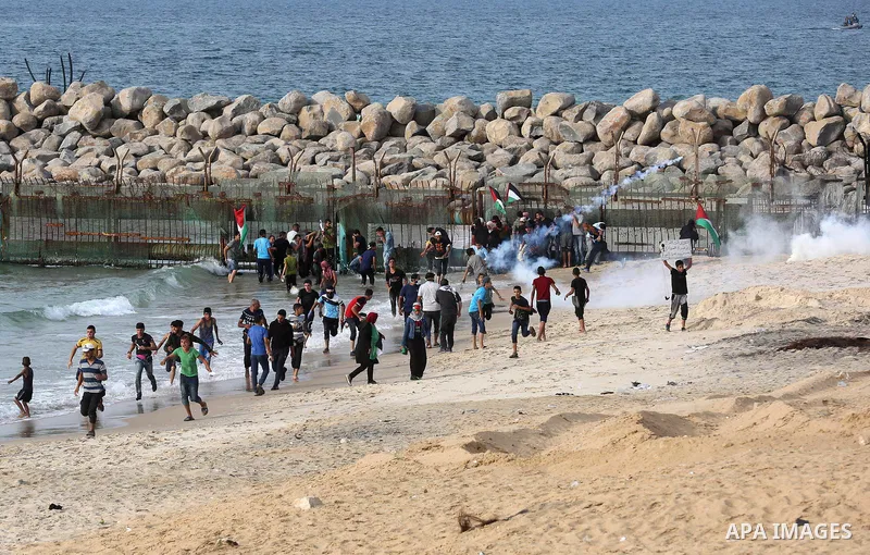 Palestinian protesters gather during clashes with Israeli forces in a demonstration against the Israeli blockade on Gaza Strip, along the Gaza sea barrier on the maritime border with Israel near Kibbutz Zikim, north of B...