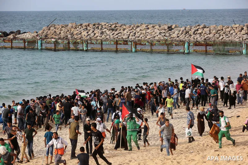 Palestinian protesters gather during clashes with Israeli forces in a demonstration against the Israeli blockade on Gaza Strip, along the Gaza sea barrier on the maritime border with Israel near Kibbutz Zikim, north of B...