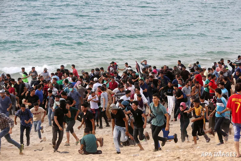 Palestinian protesters gather during clashes with Israeli forces in a demonstration against the Israeli blockade on Gaza Strip, along the Gaza sea barrier on the maritime border with Israel near Kibbutz Zikim, north of B...