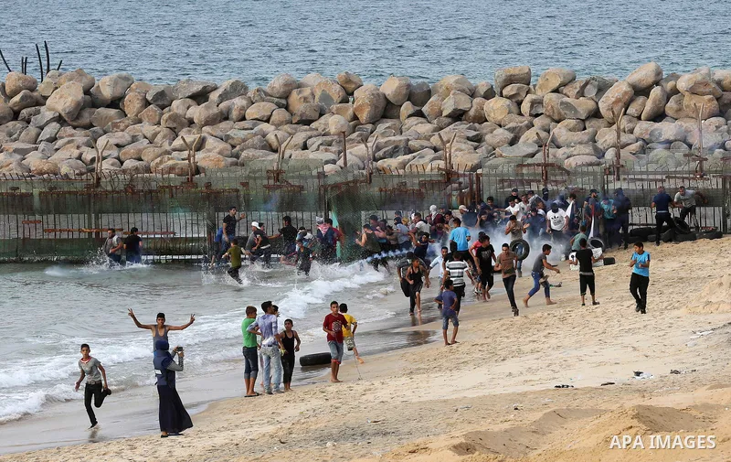 Palestinian protesters gather during clashes with Israeli forces in a demonstration against the Israeli blockade on Gaza Strip, along the Gaza sea barrier on the maritime border with Israel near Kibbutz Zikim, north of B...