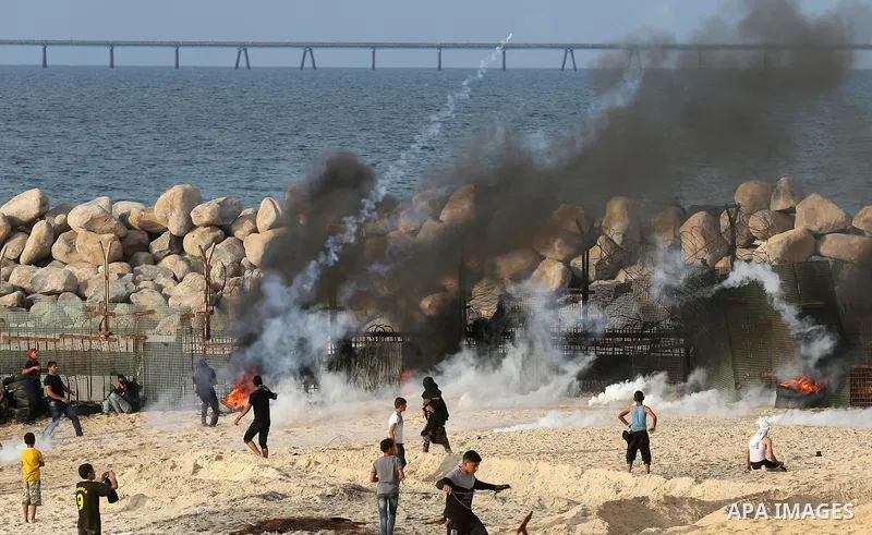 Palestinian protesters gather during clashes with Israeli forces in a demonstration against the Israeli blockade on Gaza Strip, along the Gaza sea barrier on the maritime border with Israel near Kibbutz Zikim, north of B...