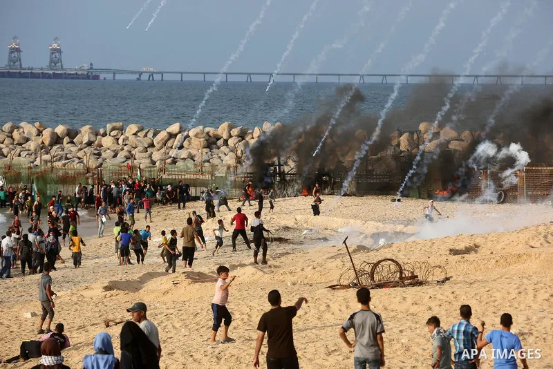 Palestinian protesters gather during clashes with Israeli forces in a demonstration against the Israeli blockade on Gaza Strip, along the Gaza sea barrier on the maritime border with Israel near Kibbutz Zikim, north of B...