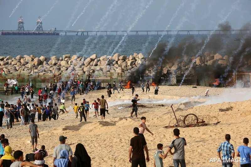Palestinian protesters gather during clashes with Israeli forces in a demonstration against the Israeli blockade on Gaza Strip, along the Gaza sea barrier on the maritime border with Israel near Kibbutz Zikim, north of B...