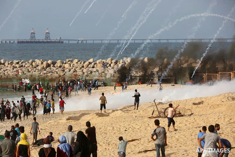 Palestinian protesters gather during clashes with Israeli forces in a demonstration against the Israeli blockade on Gaza Strip, along the Gaza sea barrier on the maritime border with Israel near Kibbutz Zikim, north of B...