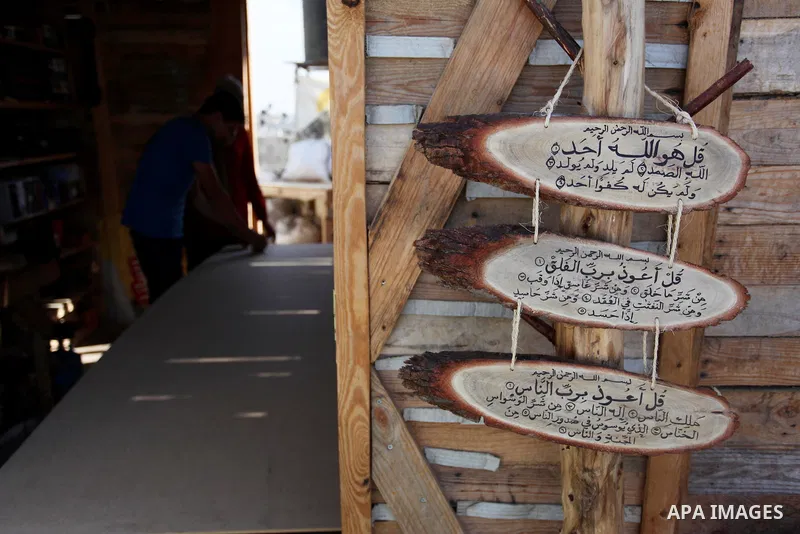 A Palestinian Nedal al-Nakhala, 20, and his sister Heba, 22, work at their workshop "Antica Home", where they manufacture wooden products to sell it for customers, in Gaza City on October 16, 2018. Photo by Mahmoud Ajjou...