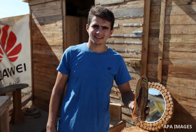 A Palestinian Nedal al-Nakhala, 20, displays wooden products which he was manufacture it with his sister Heba, 22, to sell it for customers, in Gaza City on October 16, 2018. Photo by Mahmoud Ajjour