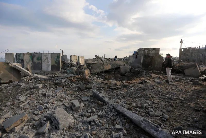 Palestinian men inspect the site targeted by an Israeli air strike, in Rafah in the southern Gaza strip on October 17, 2018. Photo by Ashraf Amra