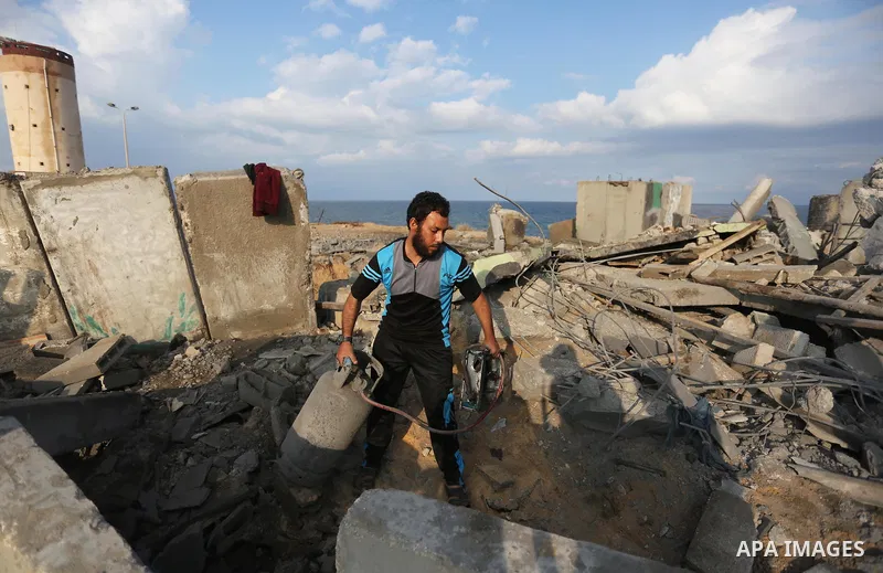 A Palestinian man inspects the site targeted by an Israeli air strike, in Rafah in the southern Gaza strip on October 17, 2018. Photo by Ashraf Amra