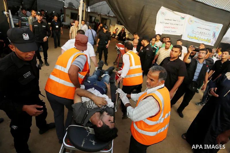 A Palestinian protester who was wounded during clashes with Israeli froces at the Israel-Gaza border, receives treatment at a medical tent, in Khan Younis in the southern Gaza Strip on October 19, 2018. Photo by Ashraf A...