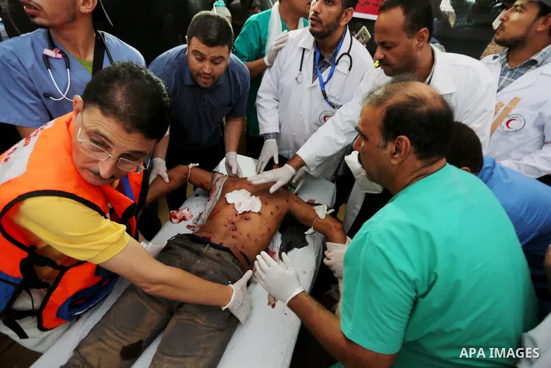 A Palestinian protester who was wounded during clashes with Israeli froces at the Israel-Gaza border, receives treatment at a medical tent, in Khan Younis in the southern Gaza Strip on October 19, 2018. Photo by Ashraf A...