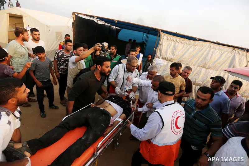 A Palestinian protester who was wounded during clashes with Israeli froces at the Israel-Gaza border, is carried on stretcher, in Khan Younis in the southern Gaza Strip on October 19, 2018. Photo by Ashraf Amra