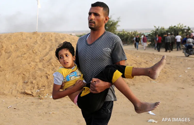 A wounded Palestinian protester is evacuated during clashes with Israeli troops in tents protest where Palestinians demand the right to return to their homeland at the Israel-Gaza border, in Khan Younis in the southern G...