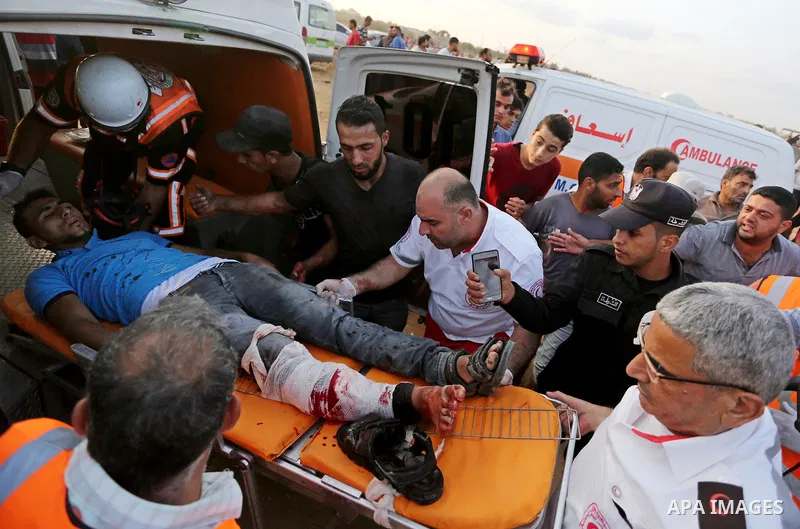 A Palestinian protester who was wounded during clashes with Israeli froces at the Israel-Gaza border, is carried on stretcher, in Khan Younis in the southern Gaza Strip on October 19, 2018. Photo by Ashraf Amra