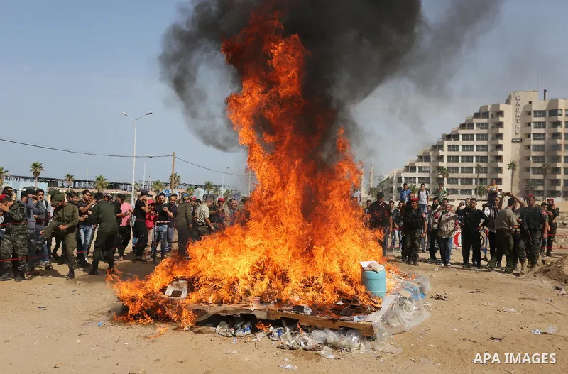 Members of Palestinian anti-drug police burn drugs during the annual conference for the destruction of narcotics, in Gaza City on October 22, 2018. Photo by Ashraf Amra