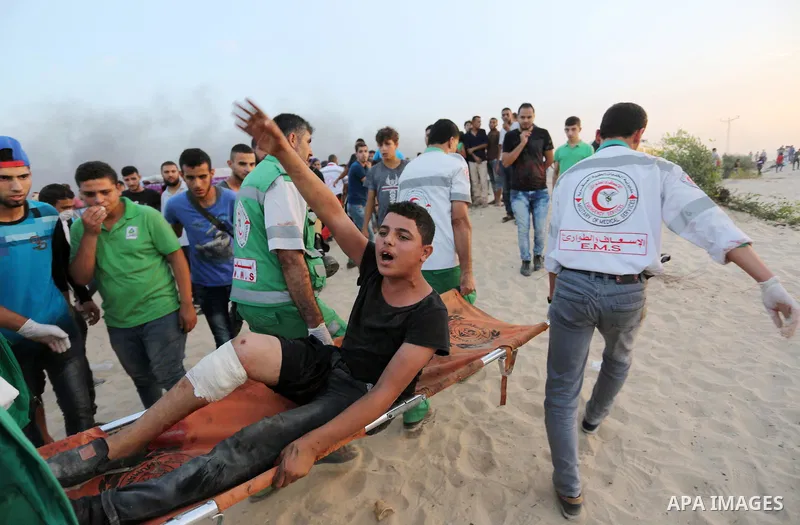 A wounded Palestinian protester is evacuated during clashes with Israeli forces in a demonstration against the Israeli blockade on Gaza Strip, along the Gaza sea barrier on the maritime border with Israel near Kibbutz Zi...