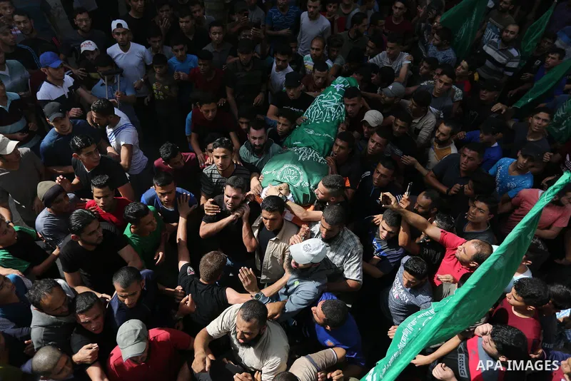Mourners carry the body of Palestinian Muntaser al-Baz, who was shot dead by Israeli forces during a protest at the Israel-Gaza border, during his funeral in Dair Al Balah in the central Gaza Strip, on October 24, 2018....