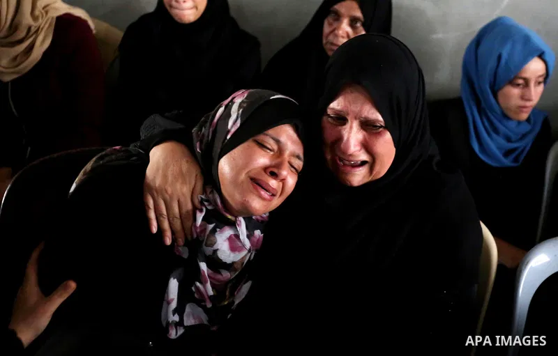 Relatives of Palestinian Muntaser al-Baz, who was shot dead by Israeli forces during a protest at the Israel-Gaza border, mourn during his funeral in Dair Al Balah in the central Gaza Strip, on October 24, 2018. Photo by...