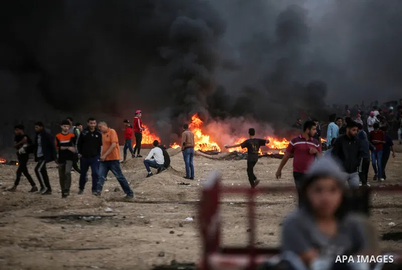 Palestinian protesters gather during clashes with Israeli troops in tents protest where Palestinians demand the right to return to their homeland at the Israel-Gaza border, in east of Gaza City on October 26, 2018. Photo...