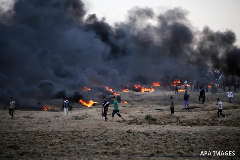 Palestinian protesters gather during clashes with Israeli troops in tents protest where Palestinians demand the right to return to their homeland at the Israel-Gaza border, in east of Gaza City on October 26, 2018. Photo...