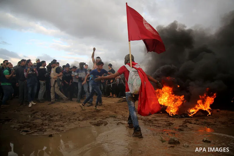 Palestinian protesters gather during clashes with Israeli troops in tents protest where Palestinians demand the right to return to their homeland at the Israel-Gaza border, in east of Gaza City on October 26, 2018. Photo...