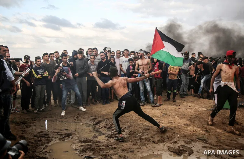 Palestinian protesters gather during clashes with Israeli troops in tents protest where Palestinians demand the right to return to their homeland at the Israel-Gaza border, in east of Gaza City on October 26, 2018. Photo...