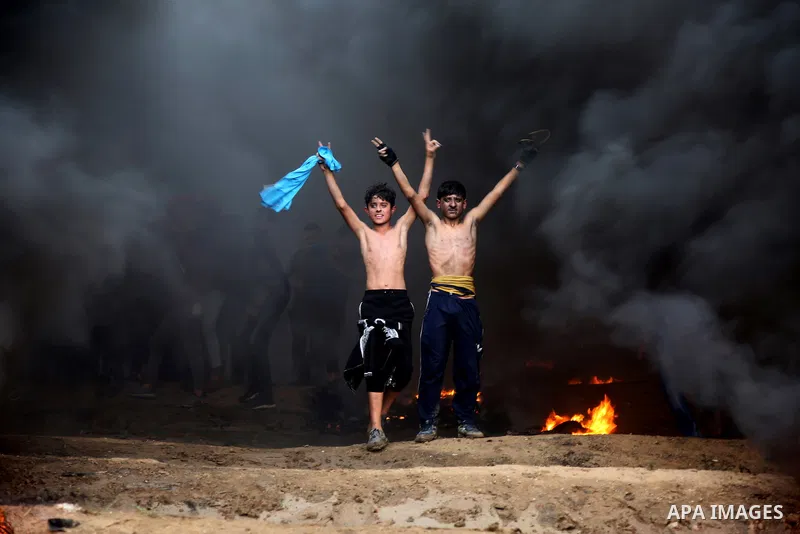Palestinian protesters gather during clashes with Israeli troops in tents protest where Palestinians demand the right to return to their homeland at the Israel-Gaza border, in east of Gaza City on October 26, 2018. Photo...