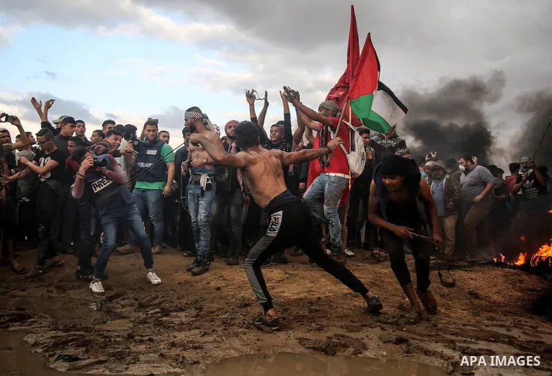 Palestinian protesters gather during clashes with Israeli troops in tents protest where Palestinians demand the right to return to their homeland at the Israel-Gaza border, in east of Gaza City on October 26, 2018. Photo...