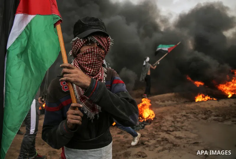 Palestinian protesters gather during clashes with Israeli troops in tents protest where Palestinians demand the right to return to their homeland at the Israel-Gaza border, in east of Gaza City on October 26, 2018. Photo...