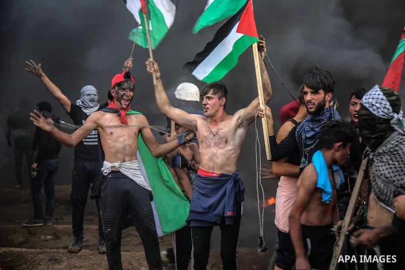 Palestinian protesters gather during clashes with Israeli troops in tents protest where Palestinians demand the right to return to their homeland at the Israel-Gaza border, in east of Gaza City on October 26, 2018. Photo...