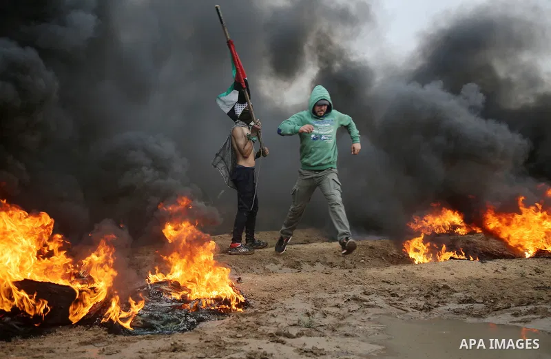 Palestinian protesters gather during clashes with Israeli troops in tents protest where Palestinians demand the right to return to their homeland at the Israel-Gaza border, in east of Gaza City on October 26, 2018. Photo...