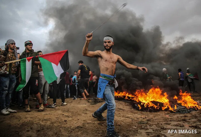 Palestinian protesters gather during clashes with Israeli troops in tents protest where Palestinians demand the right to return to their homeland at the Israel-Gaza border, in east of Gaza City on October 26, 2018. Photo...