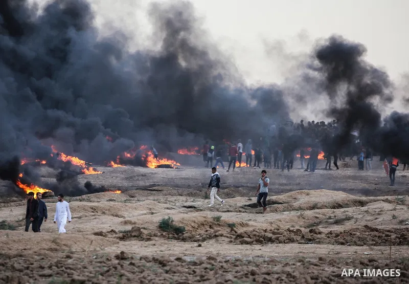 Palestinian protesters gather during clashes with Israeli troops in tents protest where Palestinians demand the right to return to their homeland at the Israel-Gaza border, in east of Gaza City on October 26, 2018. Photo...