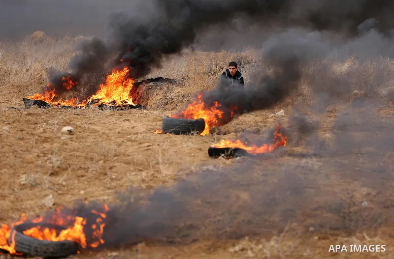 Palestinian protesters gather during clashes with Israeli troops in tents protest where Palestinians demand the right to return to their homeland at the Israel-Gaza border, in Khan Youins in the southern Gaza Strip on Oc...