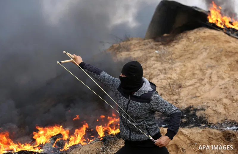 Palestinian protesters gather during clashes with Israeli troops in tents protest where Palestinians demand the right to return to their homeland at the Israel-Gaza border, in Khan Youins in the southern Gaza Strip on Oc...