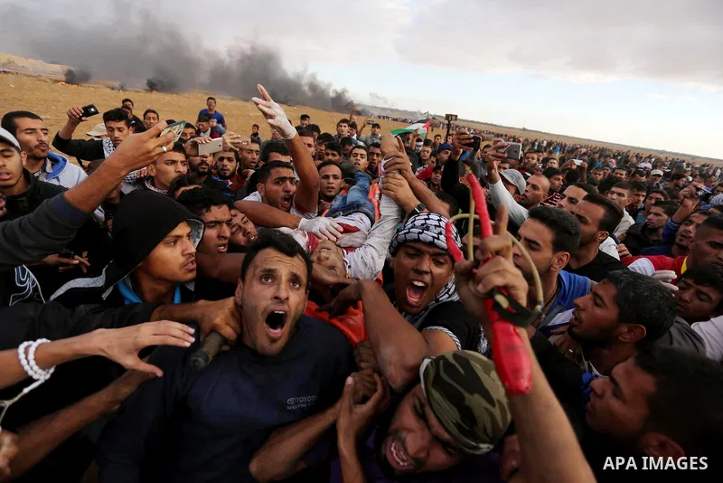 A wounded Palestinian protester is evacuated during clashes with Israeli troops in tents protest where Palestinians demand the right to return to their homeland at the Israel-Gaza border, in Khan Youins in the southern G...