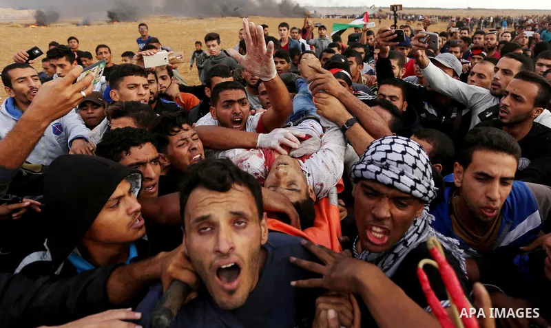A wounded Palestinian protester is evacuated during clashes with Israeli troops in tents protest where Palestinians demand the right to return to their homeland at the Israel-Gaza border, in Khan Youins in the southern G...