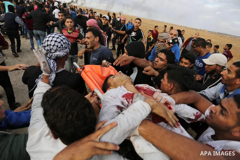 A wounded Palestinian protester is evacuated during clashes with Israeli troops in tents protest where Palestinians demand the right to return to their homeland at the Israel-Gaza border, in Khan Youins in the southern G...