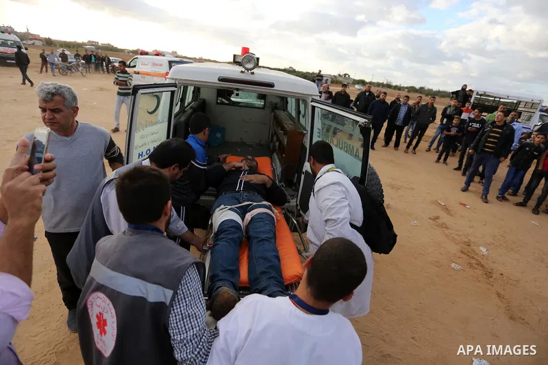 A wounded Palestinian protester is evacuated during clashes with Israeli troops in tents protest where Palestinians demand the right to return to their homeland at the Israel-Gaza border, in Khan Youins in the southern G...
