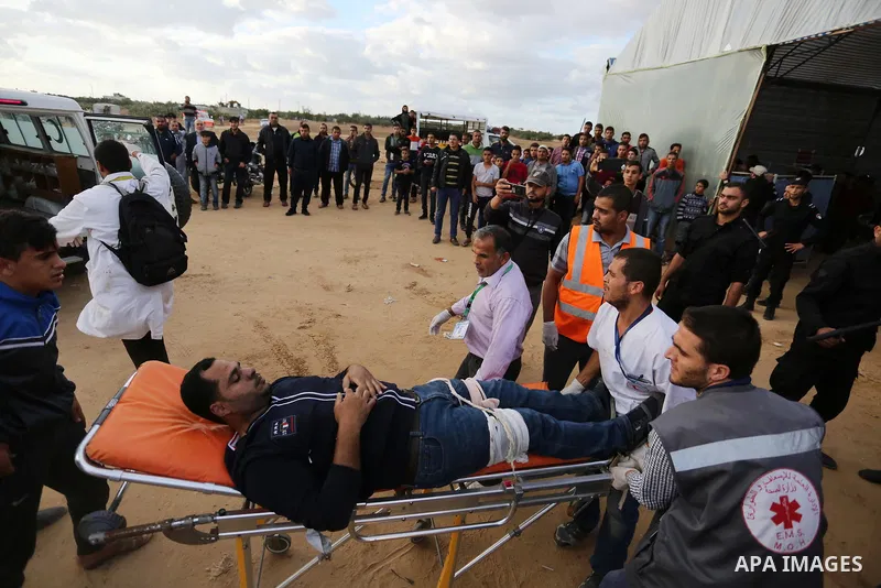 A wounded Palestinian protester is evacuated during clashes with Israeli troops in tents protest where Palestinians demand the right to return to their homeland at the Israel-Gaza border, in Khan Youins in the southern G...
