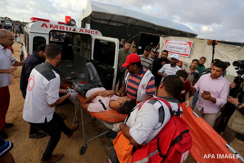 A wounded Palestinian protester is evacuated during clashes with Israeli troops in tents protest where Palestinians demand the right to return to their homeland at the Israel-Gaza border, in Khan Youins in the southern G...